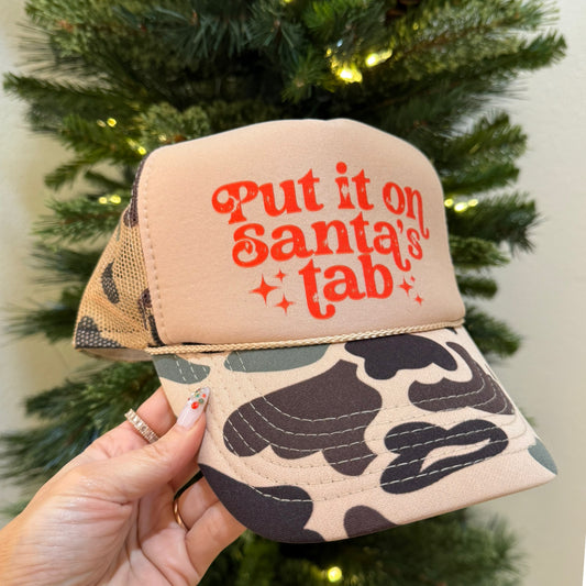 Camo Put it on Santa’s Tab or Merry Trucker Hat